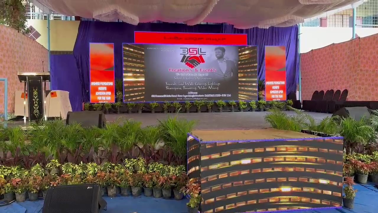 BSL-branded LED stage with planter façade (daytime build)