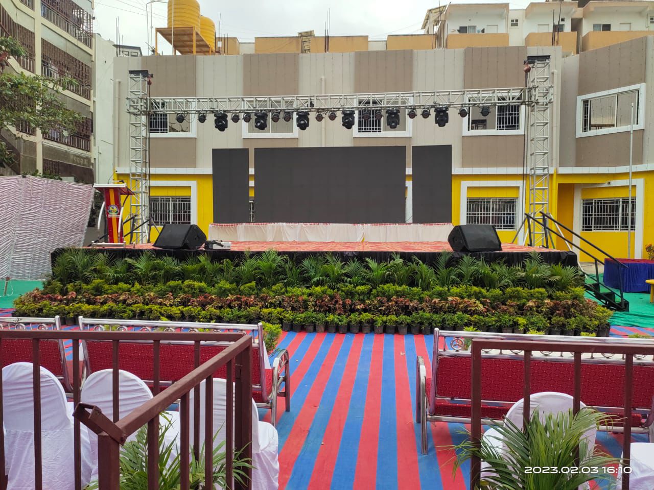 Outdoor stage build with LED wall, truss and planter dressing
